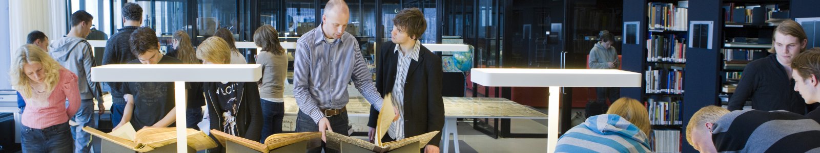 Student and curator in the map room of Special Collections