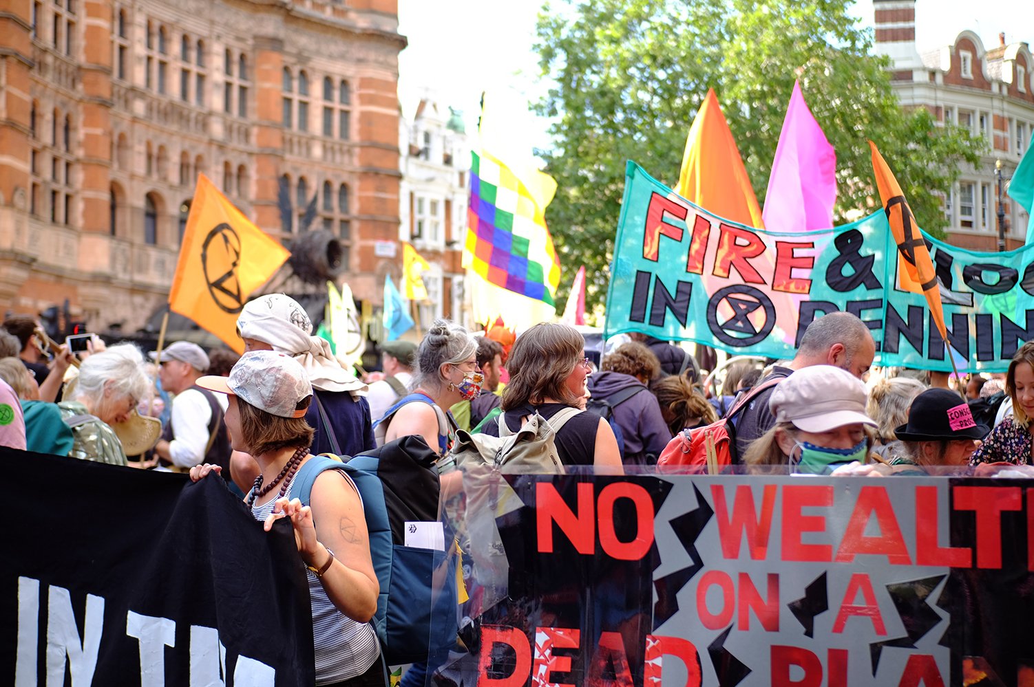 Extinction Rebellion demonstration with colourfull signs and flags and people masking