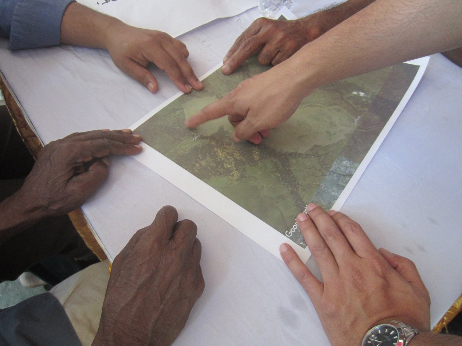 Photo of a stakeholder discussion over a map