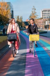 Students biking on the rainbow lane