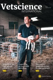 Cover Vetscience international 2021, young student is holding a new born lamb in the farm of the faculty of Veterinary Medicine