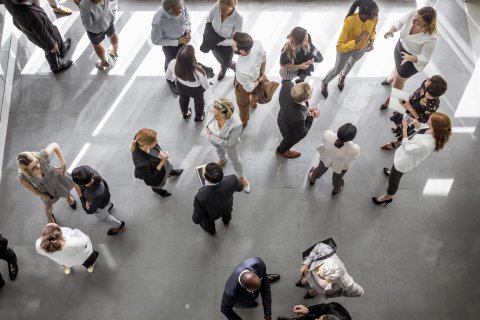 People dispersed in a room, photographed from above