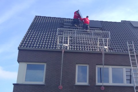Zonnepanelen worden geïnstalleerd op het dak van een huis