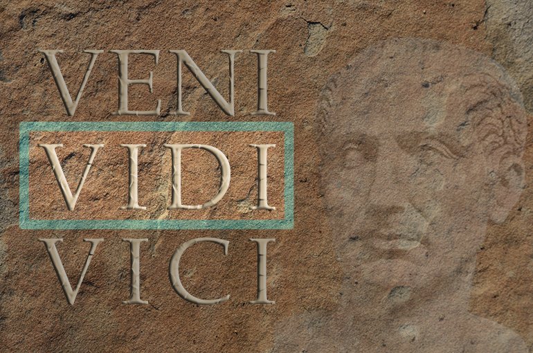 Zandstenen muur met een portret van Ceasar en de woorden Veni, Vidi, Vici