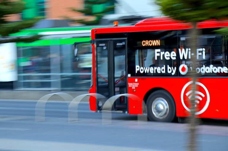 Red bus with Free WIFI advertisement in Melbourne, Australia.