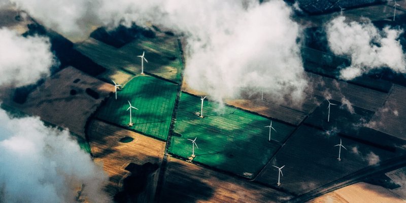 Areal photo of clouds and windmills on farmland